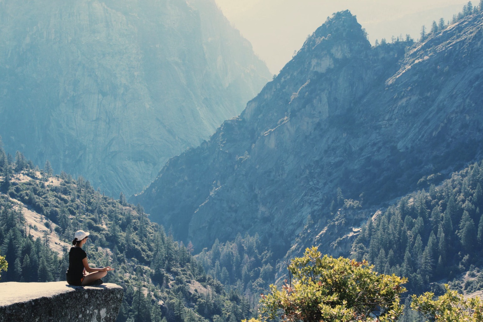 girl meditating on cliff