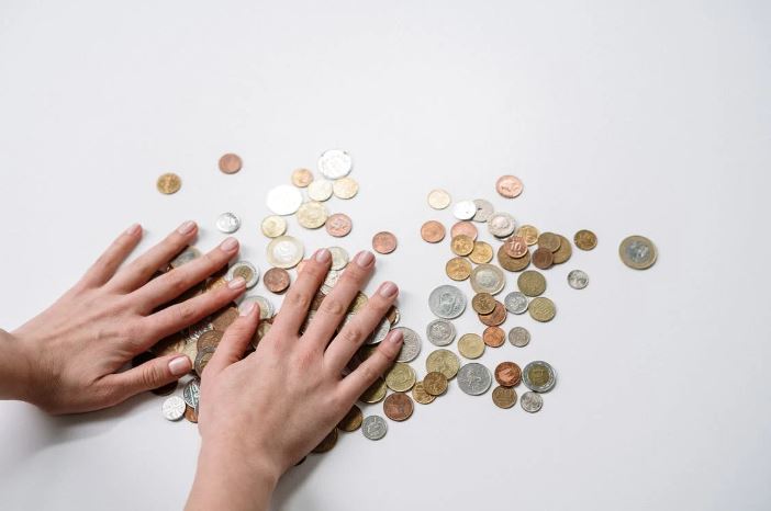 hands spreading coin