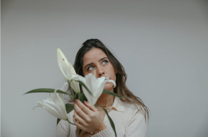 woman holding white flowers