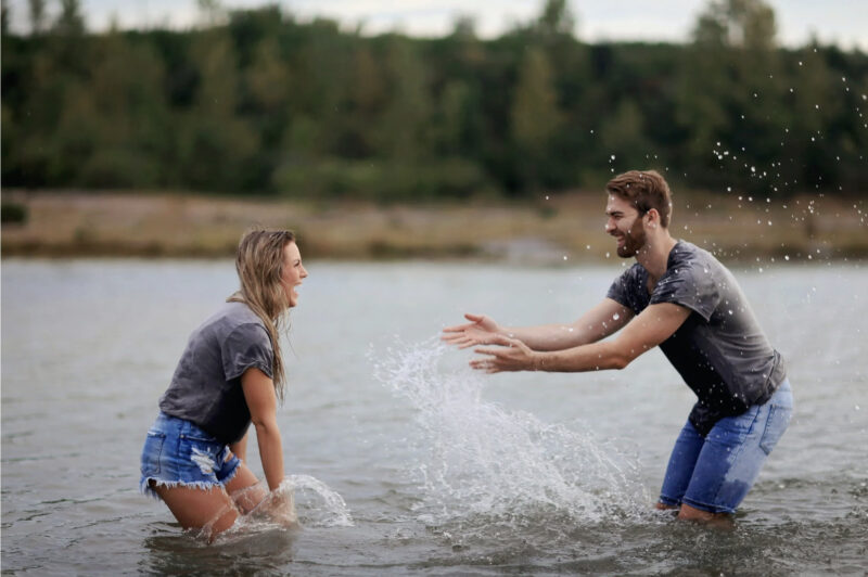 couple playing on body of water