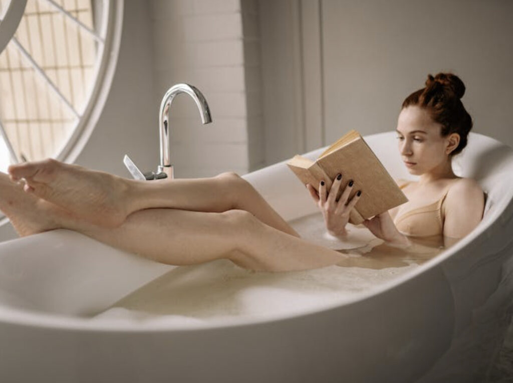 woman reading on a bath tub